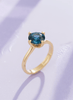 Natural Blue Topaz Twist Solitaire Ring in 14K Yellow Gold by AME Jewellery.