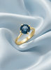 Natural Blue Topaz Twist Solitaire Ring in 14K Yellow Gold by AME Jewellery.