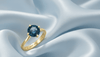 Natural Blue Topaz Twist Solitaire Ring in 14K Yellow Gold by AME Jewellery.
