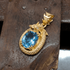 The oval Blue topaz Dragon Pendant in 14K Yellow Gold by AME Jewellery