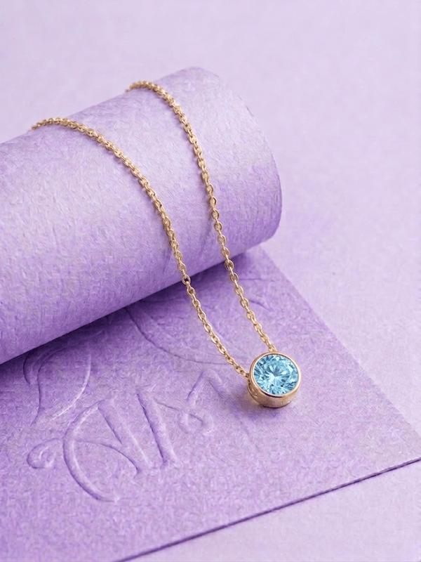 Natural Blue Zircon Bezel Pendant in 14-karat Yellow Gold by AME Jewellery.