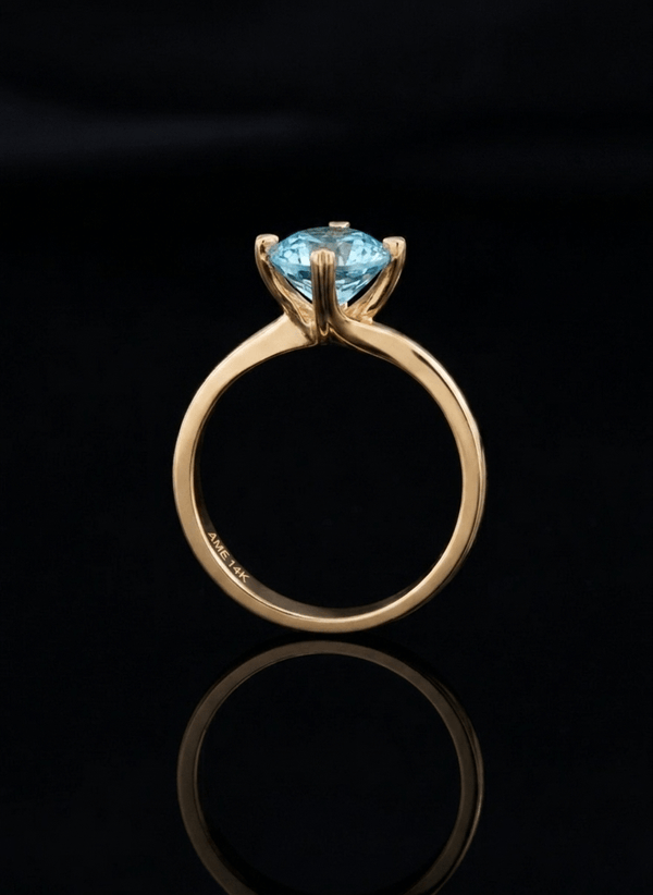 Natural Blue Zircon Twist Solitaire Ring in 14K Yellow Gold by AME Jewellery.