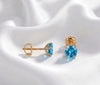 5mm Natural Blue Topaz 4-Prong Earrings in 14K Yellow Gold by AME Jewellery.