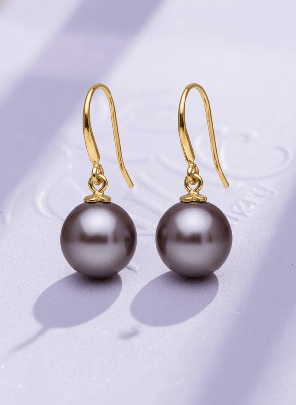 Boucles d'oreilles pendantes en or jaune 14K avec des perles de culture d'eau douce par AME Jewellery.