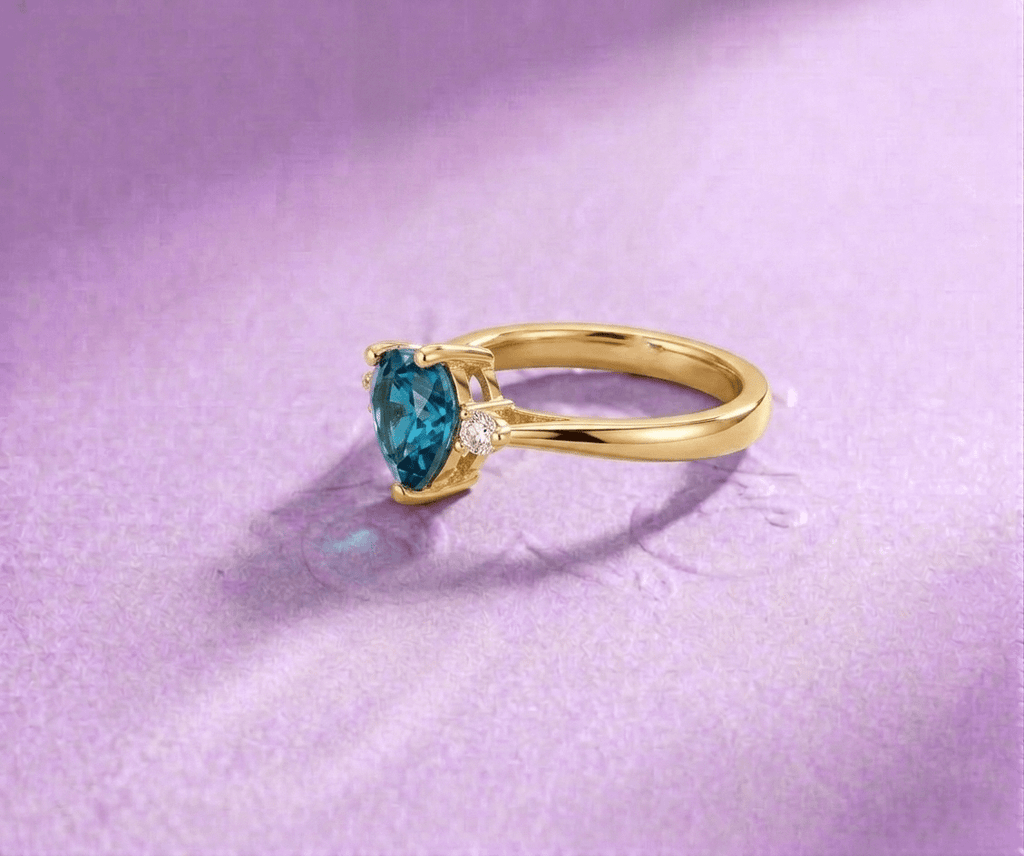 Natural Heart-cut London Blue Topaz Ring in 14K Yellow Gold by AME Jewellery.