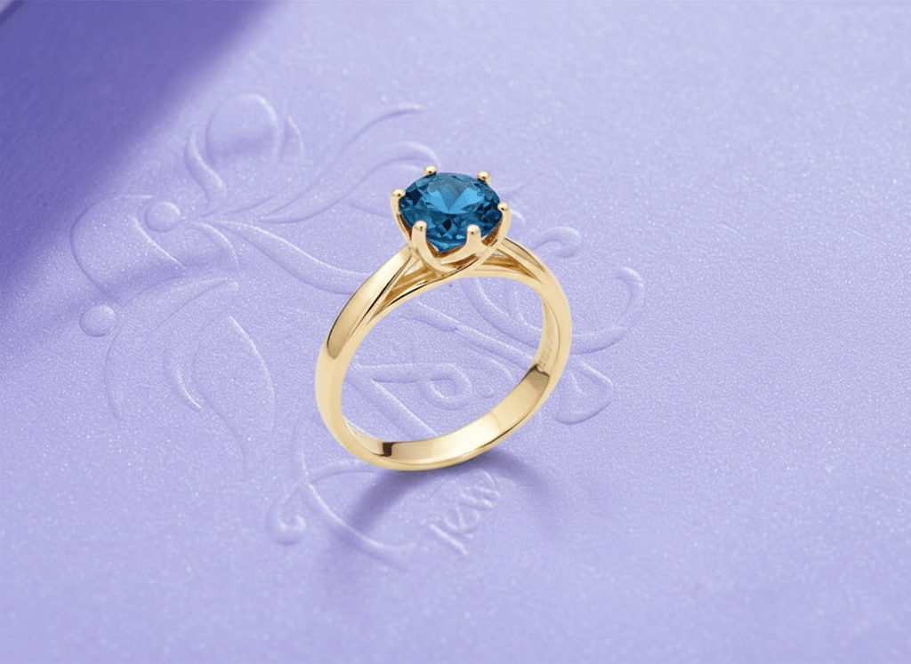 Natural Blue Topaz Twist Ring in 14K Yellow Gold by AME Jewellery.