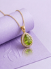 Natural Pear-cut Peridot Halo Pendant Necklace in 14K Yellow Gold by AME Jewellery. 