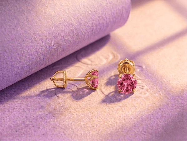Natural pink topaz 4-prong earrings in 14K yellow gold by AME Jewellery.