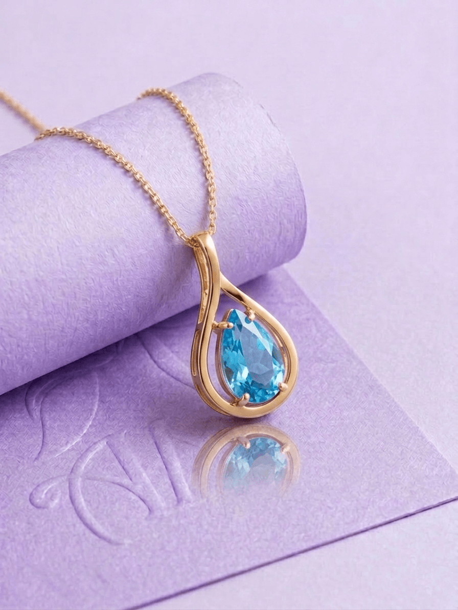 Natural Pear-shaped Blue Topaz Pendant in 14K Yellow Gold by AME Jewellery.